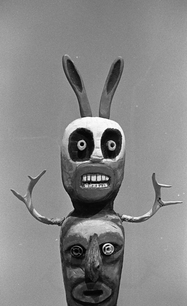 A black and white photo of a sculpture by Jim Denomie. A skull-like head with long, rabbit-like ears.