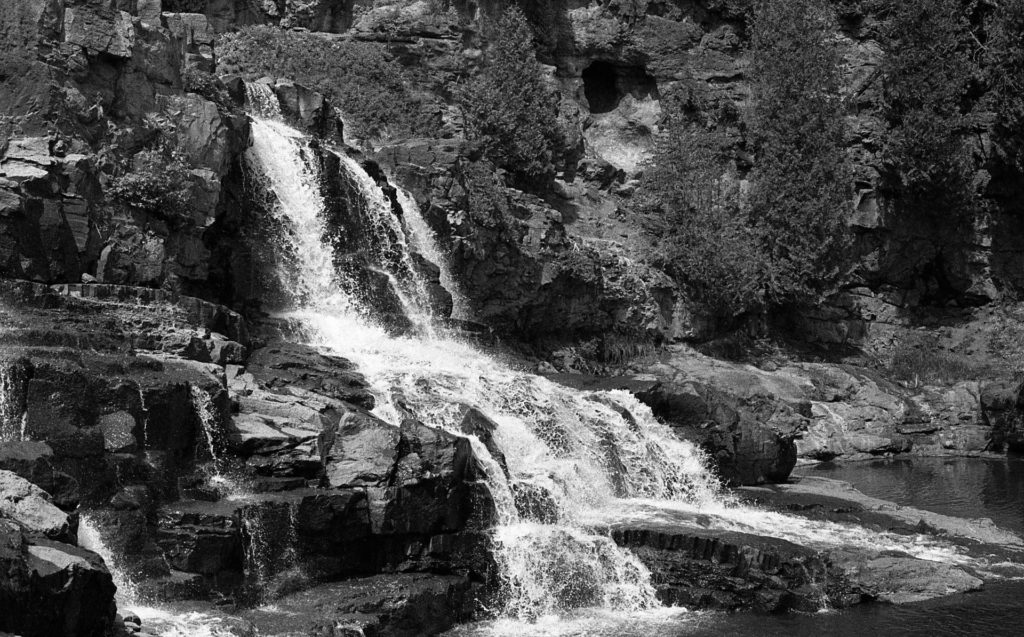 A black and white photo of a waterfall at Gooseberry Falls State Park in Minnesota